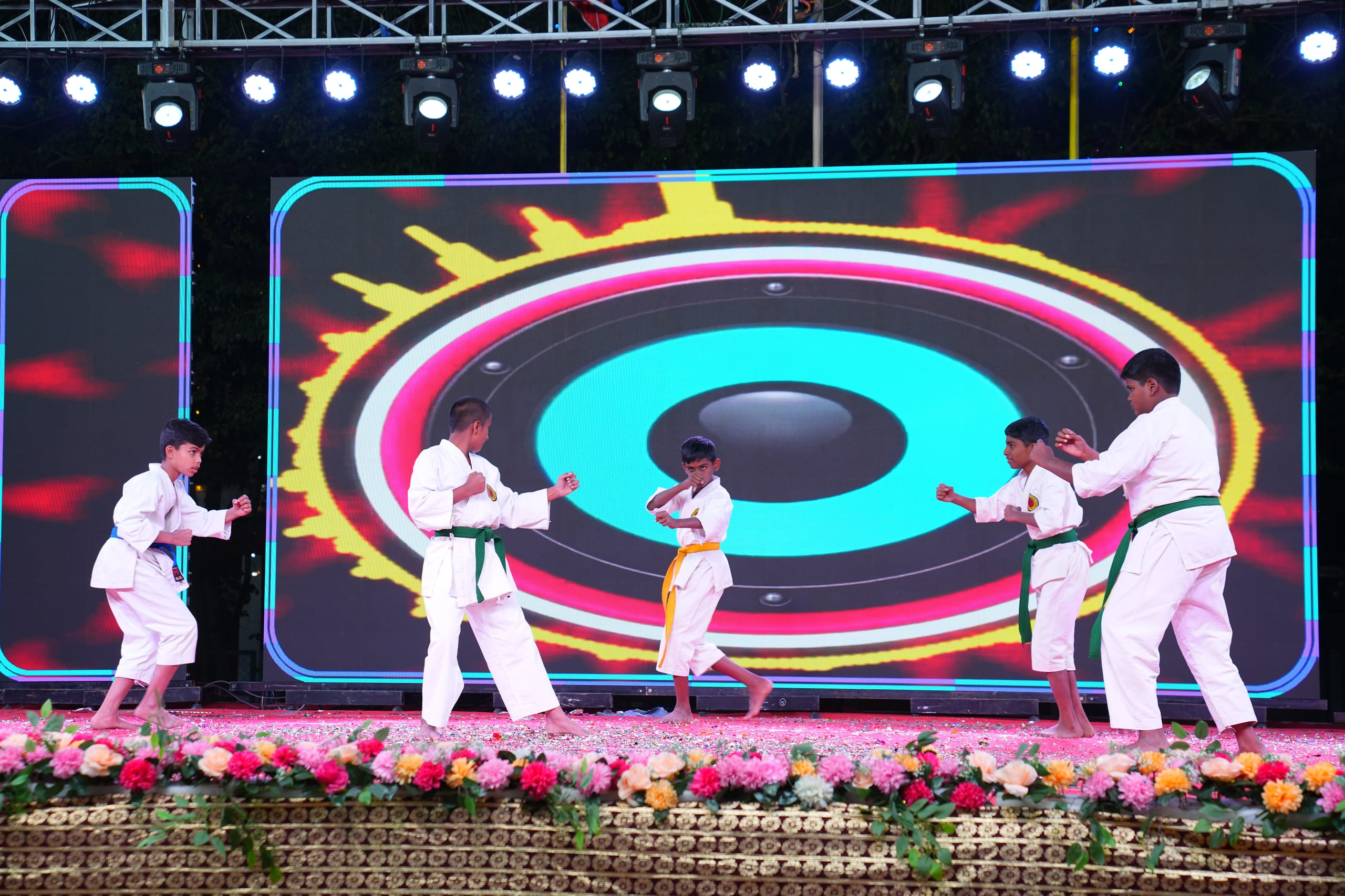 Students performing a karate and martial arts demonstration on stage