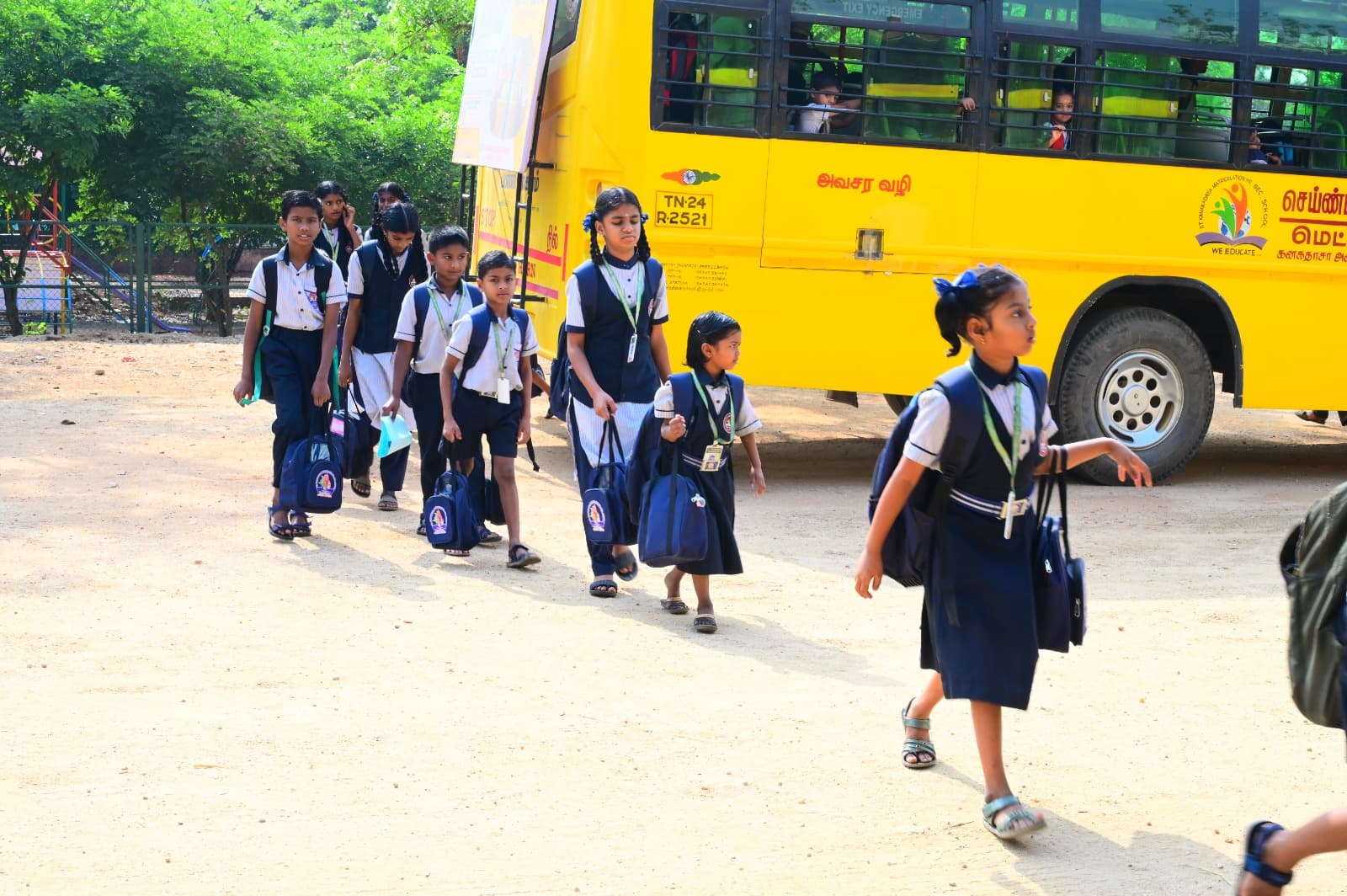 Students arriving near a yellow school bus